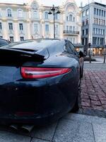 Lithuania, Vilnius, April 11, 2024 - Backlight expensive Porsche Carrera 911 photo