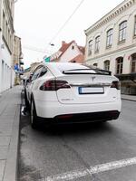 Lithuania, Vilnius, April 11, 2024 - rear view white Tesla model X photo