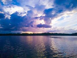 photography of the view of the sunset sky in the afternoon is purple on the sea photo