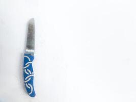 Photography of a small blue cutting knife on an isolated white background photo