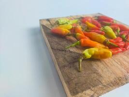 chilies in a small bowl on an isolated white background photo