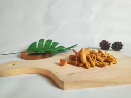 photography of cimi-cimi snacks on a wooden cutting board photo