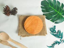 photography of circular wooden coasters with leaf ornaments on a white background suitable for mock-ups photo
