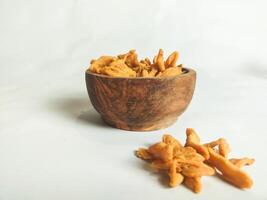 photography of cimi-cimi snack food in a wooden bowl on a white background photo
