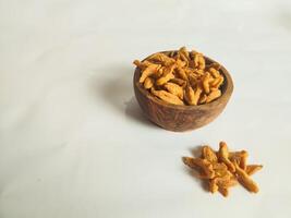 photography of cimi-cimi snack food in a wooden bowl on a white background photo