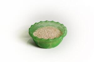 photography of rice in a plastic container on an isolated white background photo