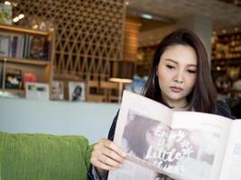 Businesswoman female lady girl person people human copy space look at newspaper copy space reading watch see look report document information lifestyle portrait young adult pretty professional success photo