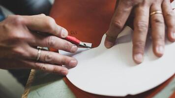 Shoe designer working with leather. photo