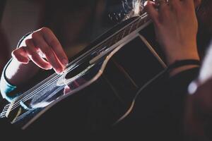 Playing classic guitar. Selective focus. photo