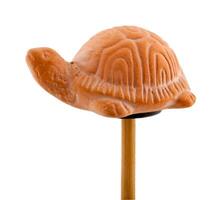 Tortoise in clay on wooden stick photo
