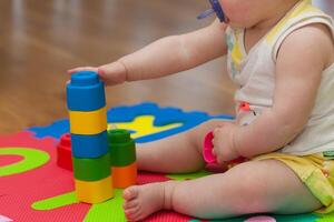 Toddler plays with building block photo