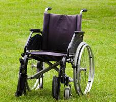 Empty wheelchair on grass field photo