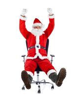 Young Santa Claus sitting on an office chair. photo