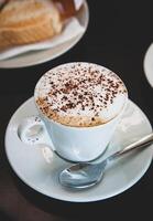 Hot mocha coffee with milk foam and cocoa powder. photo