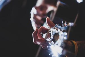 Playing classic guitar. Selective focus. photo