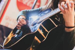 Playing classic guitar. Selective focus. photo