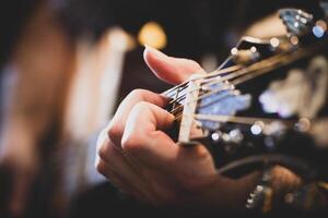 Playing classic guitar. Selective focus. photo