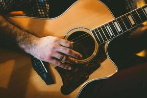 Playing classic guitar. Selective focus. photo