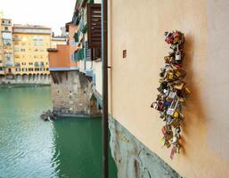 Cluster of padlocks on Ponte Vecchio Bridge photo