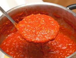 Ladle with bolognese sauce. photo