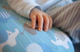 Detail of the fingers of a newborn, especially the nails. Newborn babies have long, sharp nails full of nerve endings. photo