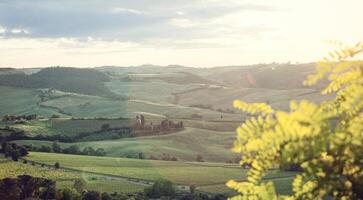 Landscape of Tuscany hills with lens flare photo