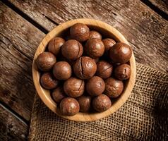 Macadamia nuts on wooden table. photo