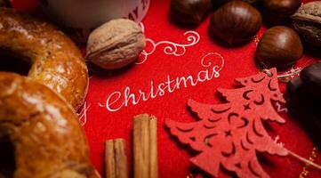 Merry Christmas text on a tablecloth with Christmas food photo