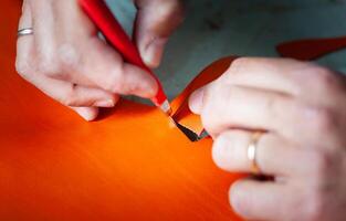 Shoe designer working with leather. photo