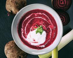 Beetroot, red borscht with sour cream and parsley photo
