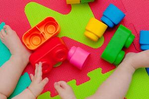 Toddler plays with building block photo