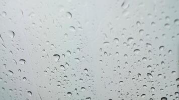 Water droplets on the front of the car windshield in the rainy season video