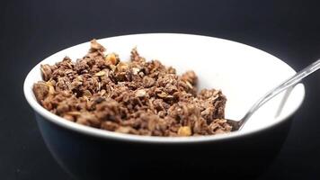 slow motion of spoon pick granola Musli in a bowl, video