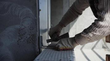 Builder banging hand hammer at the construction site video