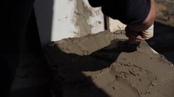 builder applies the cement mortar with a spatula video