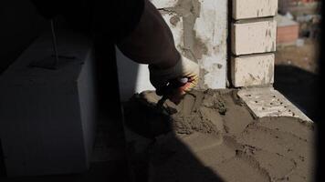 builder applies the cement mortar with a spatula video