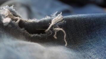 blue jean texture with a hole and ripped threads showing video
