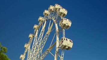 Ferris wheel with four seats on a sunny day video