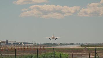 Large jetliner flying through cloudy blue sky video