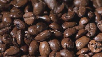 Slow mation of roasted coffee beans with smoke. Organic coffee seeds. video