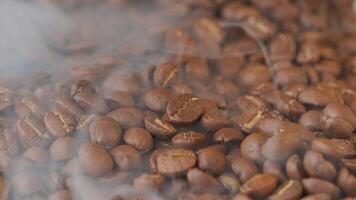 Slow mation of roasted coffee beans with smoke. Organic coffee seeds. video