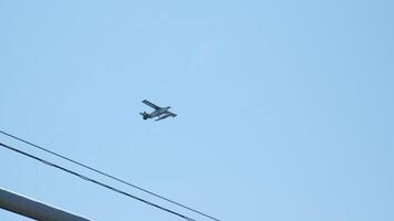 Close-up of a seaplane flying in the blue sky, slow motion. video