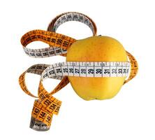Diet concept with green apple wrapped with measuring tape photo