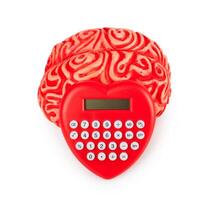 Human rubber brain with calculator heart shaped photo