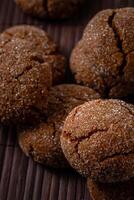 Warm Homemade Gingersnap Cookies on a wooden brown board photo