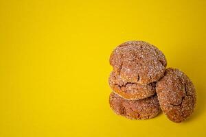Warm Homemade Gingersnap Cookies yellow background photo