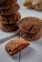 Warm Homemade Gingersnap Cookies on a wooden white board photo