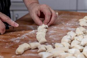 Woman kneading dough in kitchen photo