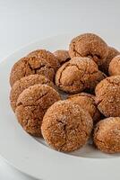 Warm Homemade Gingersnap Cookies on a light background in a plate photo