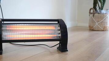 Modern electric infrared heater in living room, closeup video